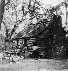 Cabin Prints: Family Working By Their Cabin Outside