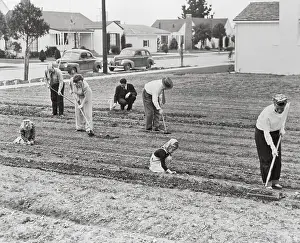 Family Working Outside in Garden