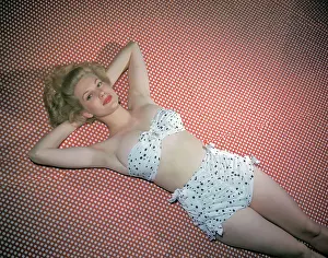 Famous Model Chili Williams Wearing Polka Dot Bikini and Lying on Dotted Red and White Fabric