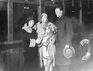 Prints of Greta Garbo, well known Swedish cinema star, is seen in center, with Mimmi Polack, Swedish screen star, and Greta's brother, who greeted her on arrival in Sweden Timeless Elegance: The Iconic Greta Garbo Collection: Famous Swedish Screen Star Arrives in Sweden for Holidays