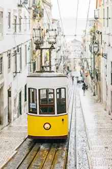 Rain Prints: Famous yellow funicular Elevador da Bica in Bairro Alto, Lisbon, Portugal