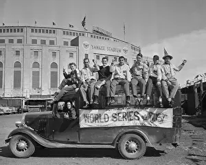 Fans Riding on Back of Truck