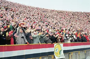 Fans Waving Flags at Football Game