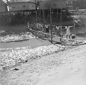Farmer Crossing Makeshift Bridge over River