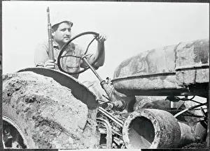 Farmer Driving Tractor with Rifle