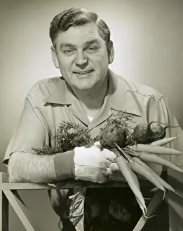 Farmer with newly picked carrots
