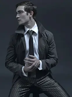 Thoughtful Prints: Fashion shot of a man in a suit and jacket, sitting on a stool