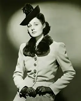 Affluent Prints: Fashionable woman in fur trimmed suit posing in studio, (B&W), portrait
