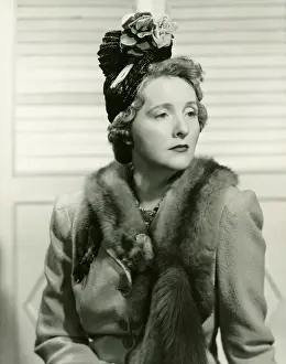 40 49 Years Prints: Fashionable woman in hat with artificial flowers posing in studio, (B&W), portrait