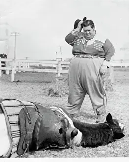 Fat Man Stands Over Fallen Horse