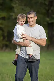 Clutch Prints: Father carrying his young son in his arms