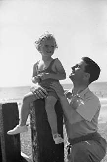 Prints of 8th October 1938: The English jockey Gordon Richards (1904 - 1986) near his home at Shoreham, West Sussex, with his daughter Marjorie Chronicling Britain's Story in Pictures: Father And Daughter