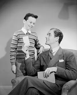 10 11 Years Prints: Father showing card to son (10-11 years)