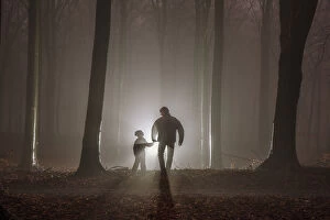 Images Dated 25th January 2016: Father and son in misty forest