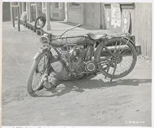 Disrepair Prints: Fatty Arbuckle Repairing Motorcycle in Movie Still