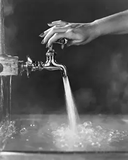 Hands Prints: Faucet Being Adjusted By Womans Hand
