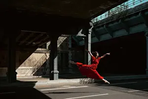 Prints of Female ballet dancer dancing with pointes in the street with a long red dress, in the street of Lyon, France The Enchanting Evolution of Ballet: Female ballet dancer dancing with pointes in the street with a long red dress