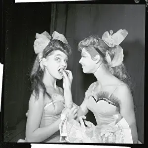 Female Dancer Hand Feeding Another