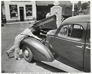 Checking Prints: Female Gas Station Attendant Checking Oil
