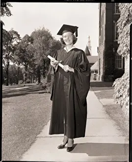 College Student Prints: Female Graduate in Cap and Gown with Diploma