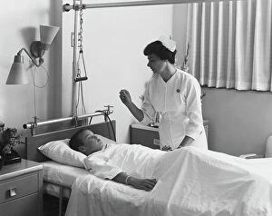 Images Dated 30th July 2011: Female nurse checking boy's temperature