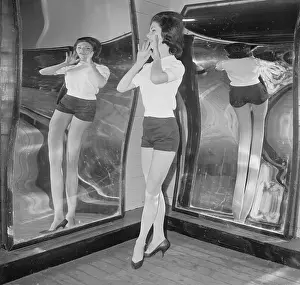 Female Patron Posing in Fun House Mirror