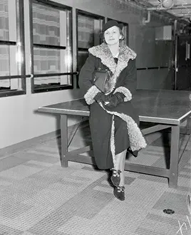 Female Socialite Sitting and Posing on Table