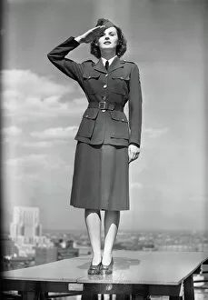 Retrofile Gallery: Female soldier standing on table and saluting