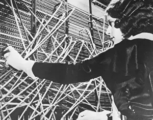 Female telephone switchboard operator connecting caller, close-up (B&W)