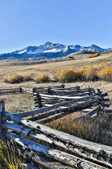 Images Dated 7th October 2017: Fence along field and snow-capped San Juan Mountains, Ridgway, Colorado, USA