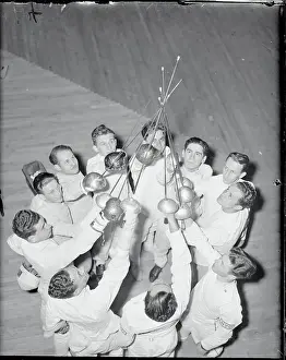 Fencing Teammates Holding Up Their Foils