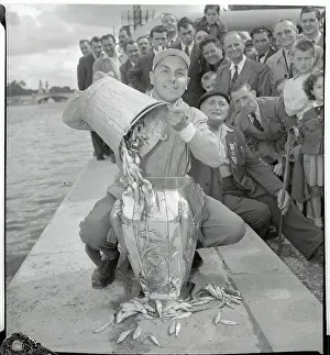 Fernand Hubert Placing Fish into a Container