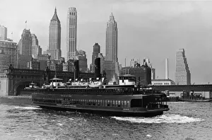 Prints of View of a ferryboat at the terminal near Battery Park with a view of the Manhattan skyscrapers in the background, New York, New York, 1932 Chrysler Building Prints: Ferry Boat At Battery Park Terminal
