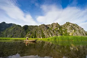 Images Dated 23rd May 2015: Ferry Woman in front of Mountain, Van Long River, Ninh Binh, Vietnam