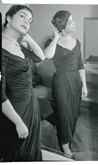 Prints of (Original Caption). Josiane Mariani Berenger, 19 year old fiancee of actor Marlon Brando, is shown as she tried on an American dress she wore at her first television appearance in Hollywood The Iconic Moments Captured: Fiancee of Actor Marlon Brando Pausing Near Mirror