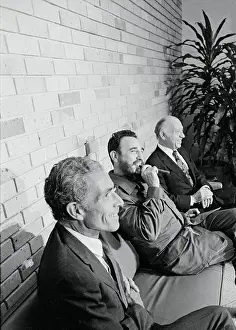 Fidel Castro Smiling and Smoking Cigar in Between American Delegates