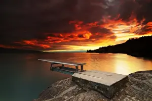 Fiery sunset over a diving board along Lake LA man
