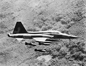 Dropping Prints: Fighter Releasing Load of Bombs Over Vietnam