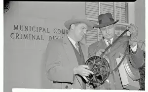 Film Workers Looking at Roll of Film