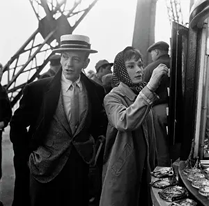 Prints of American actor, dancer and singer Fred Astaire, wearing a straw boater, and British actress Audrey Hepburn, wearing a raincoat and a headscarf Elegance Personified – A Classic Art Print Collection: Filming Funny Face, 1956