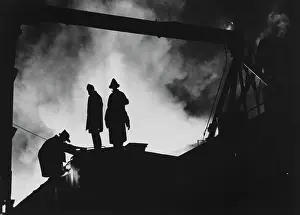 Huty30660 Prints: Firefighters Silhouetted by Fire