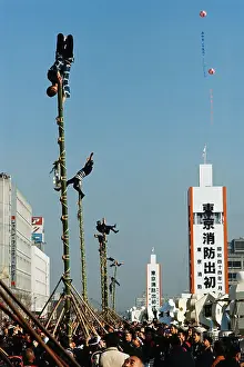 Firemen Dangling on Poles