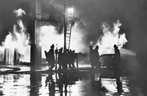 Firemen Silhouetted by Flames