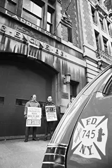 Firemen with Strike Signs Stand in Front of Firehouse
