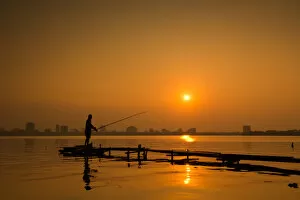 Images Dated 24th September 2014: Fisherman fishing on Hanoi West Lake on sunset, Vietnam