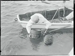 Patience Prints: Fisherman Peering Inside Bucket