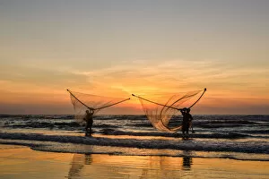 Images Dated 1st June 2014: Two Fishermen fishing on the beach at dawn in Vietnam