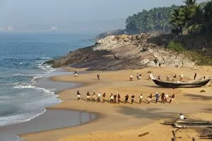 Kerala Collection: Fishermen pulling in a net, beach south of Kovalam, Vizhinjam in the distance, Malabar Coast