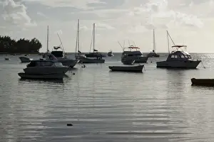 Motor Boat Prints: Floating dinghies at sunset in Bain Aux Boeuf, Mauritius, Africa