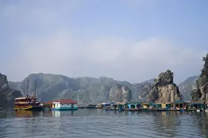 Houseboat Prints: Floating Vietnamese fishing village with rocky coastline